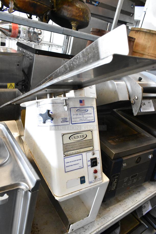 Oliver 702-N metal commercial countertop bagel slicer, 115 volts, 1 phase. Visible controls and adjustment labels.