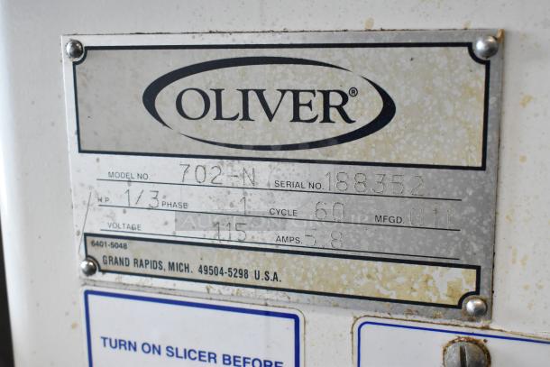 Oliver 702-N Metal Commercial Countertop Bagel Slicer label showing model, serial number, and electrical specifications.