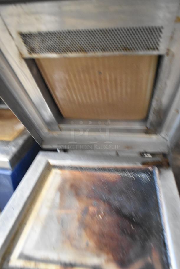Electrolux HSPPAN commercial panini press, metal construction, 208 volts, 1 phase, visible wear on pressing plates.