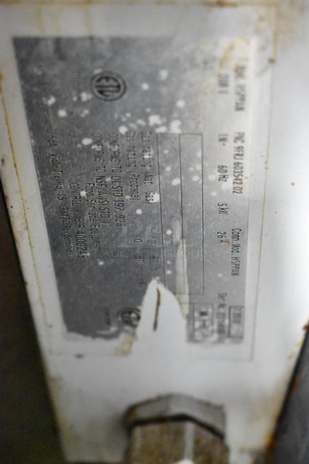 Electrolux HSPPAN metal panini press, commercial countertop model. 208 volts, 1 phase. Label shows model and specs.