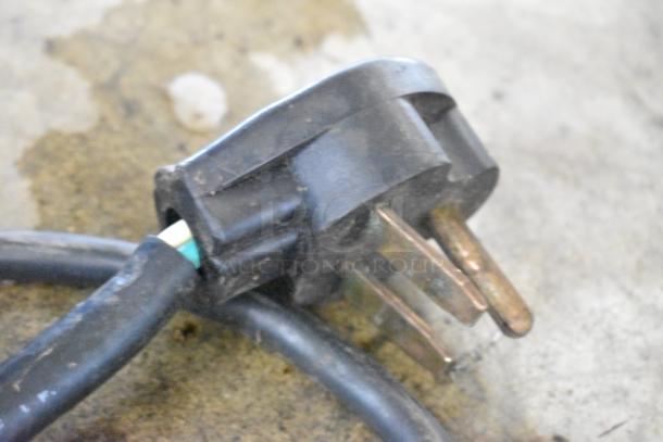 Close-up of a power plug for an Electrolux HSPPAN Panini Press, showing three prongs and part of the cable.