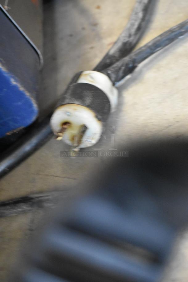Close-up of a power plug and cord from a Hatco TQ-800HBA Toast Qwik conveyor toaster oven. Condition appears worn.