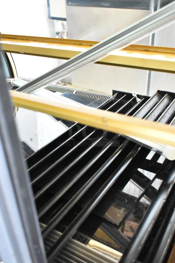 Kinco NSRM3 metal deli display case in used condition. Features glass shelves, metal framing, and interior lighting. 110V, 1 phase.