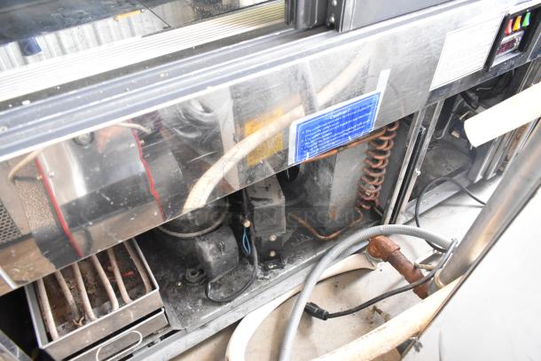 Kinco NSRM3 metal deli display case, commercial floor style. Features include internal coils, wiring, and caution labels. 110V, 1 phase.