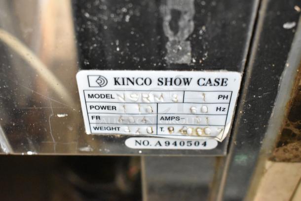 Kinco NSRM3 Deli Display Case info tag showing model, power 110V, 1 phase, and serial number A940504.