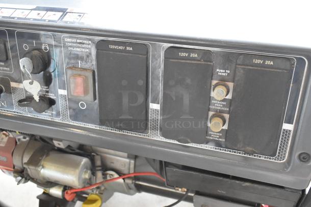 Briggs & Stratton Elite Series 030549 Generator, control panel view with switches, key, and voltage outlets, in used condition.