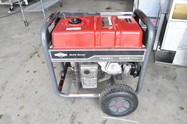 Briggs & Stratton Elite Series 030549 Generator, 7500W, red fuel tank, mounted on wheels, in used condition.