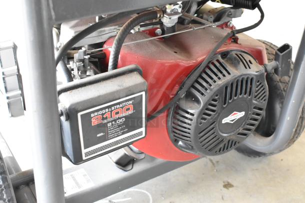 Briggs & Stratton Elite Series 030549 Generator, 2100 Engine Series, visible label, red and black, in used condition.