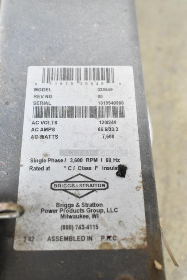 Briggs & Stratton Elite Series 030549 Generator label showing model, serial number, voltage, and wattage details.