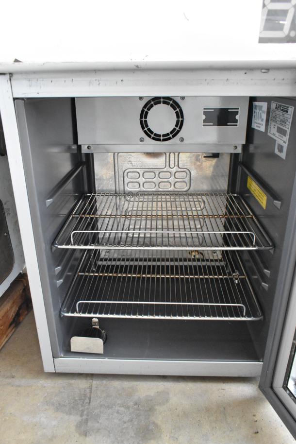 AHT Coolpoint CMV 50 metal single door mini cooler, 115 volts, two wire shelves, visible interior fan, and labels.