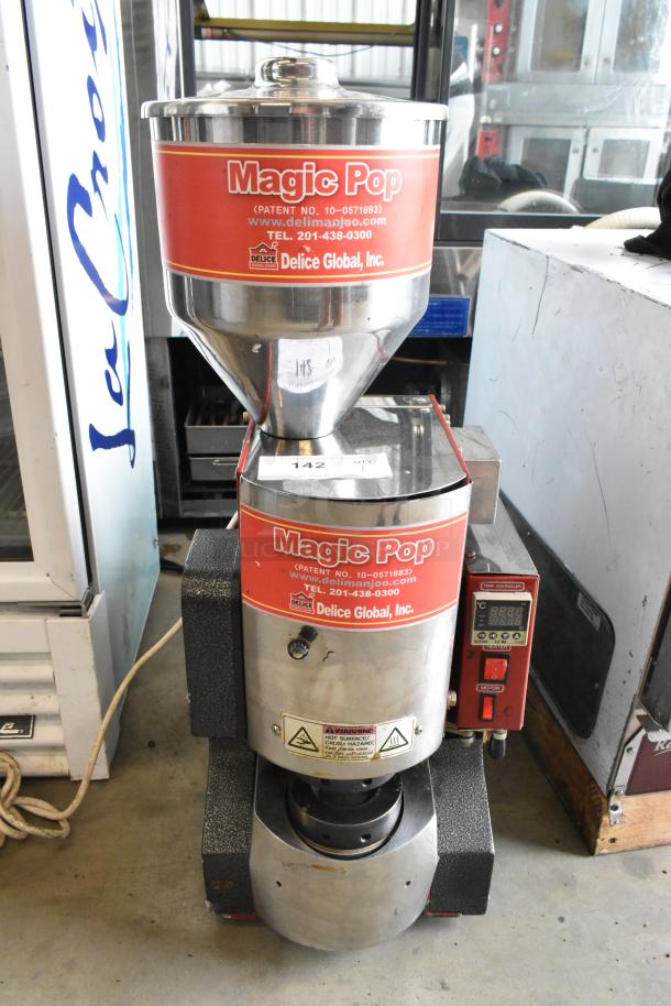 Magic Pop DMP-1 metal rice cake machine, 115V, 1 phase. Features brand label, warning signs, patent, and contact info.