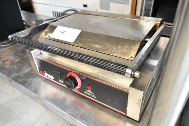 Winco EPG-1 stainless steel commercial panini press, 120 volts, visible wear, labeled with model name and heat dial.