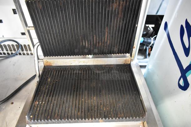 Winco EPG-1 Stainless Steel Commercial Panini Press, ribbed plates, 120V, 1 Phase. Visible wear on cooking surfaces.