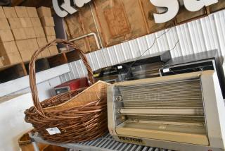 Three items including two wicker baskets and a Vector E123180 bug zapper, displayed on a metal shelf.