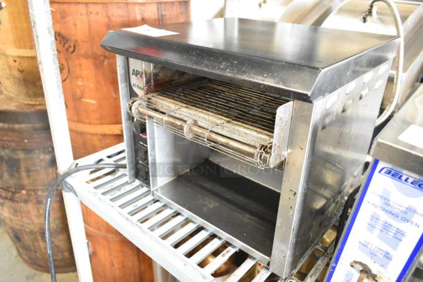 APW Wyott AT EXPRESS stainless steel conveyor toaster oven, 240V, 1 phase, commercial countertop model; some wear visible.