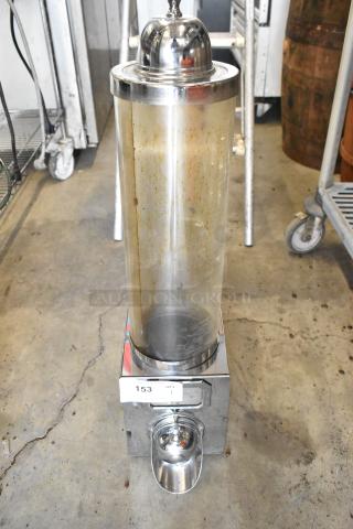 Metal dry dispenser with transparent cylindrical container, silver accents, and scoop tray. Shows wear, auction tag "153".