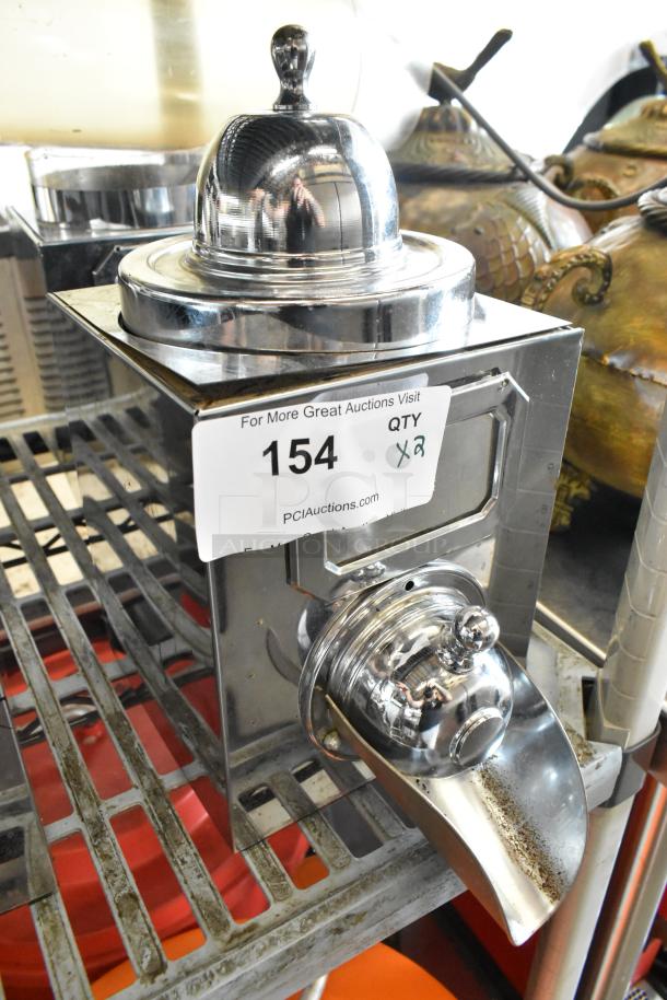 Two shiny metal dry dispensers, reflective finish, auction tag 154, quantity 2, ideal for storing dry goods.