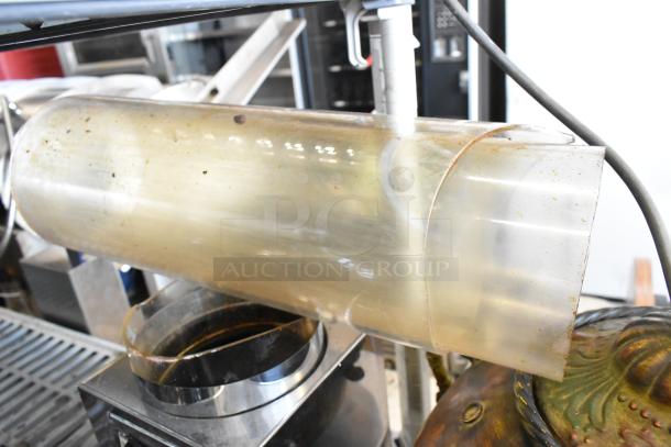 Two metal dry dispensers in used condition. Features a cylindrical body with visible wear, suitable for bulk dispensing.
