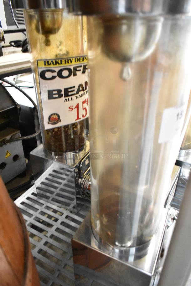 Three metal dry dispensers, labeled for coffee beans, in good condition. Features transparent chambers and price tag for $15.49.
