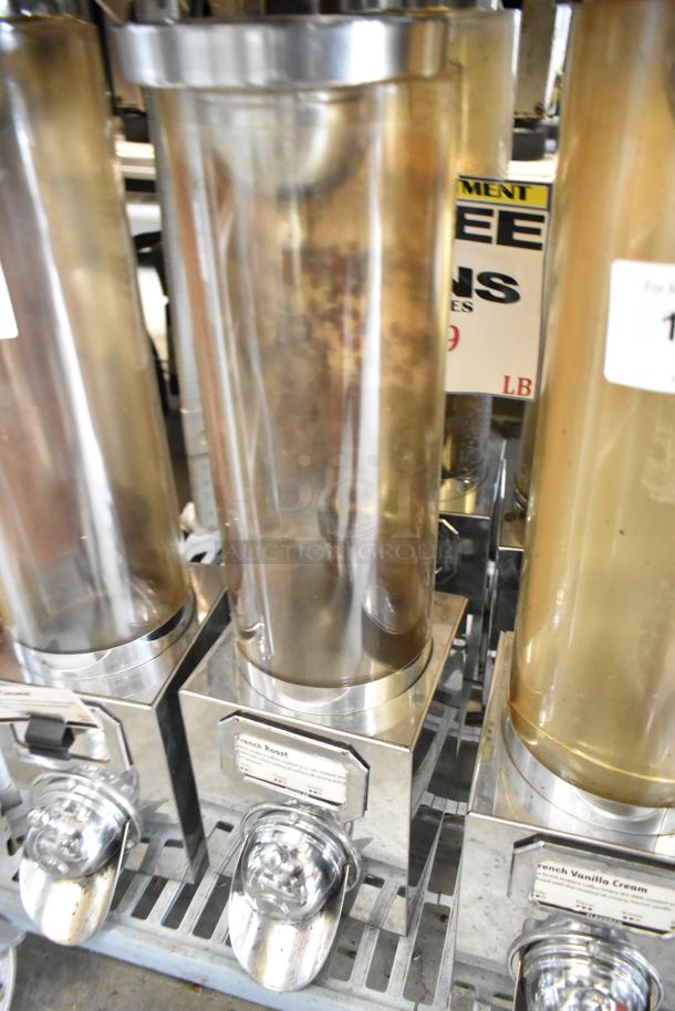 3 metal dry dispensers with clear cylindrical containers and chrome bases. Labels visible for French Roast and Vanilla Cream.
