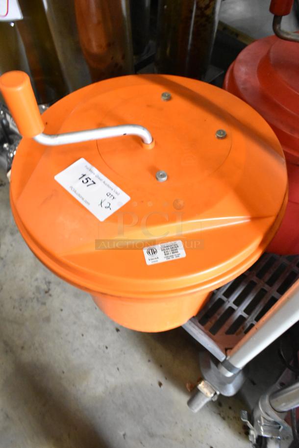 Orange Poly Lettuce Spinner with hand crank, visibly labeled. Sturdy condition, ideal for efficient salad prep.