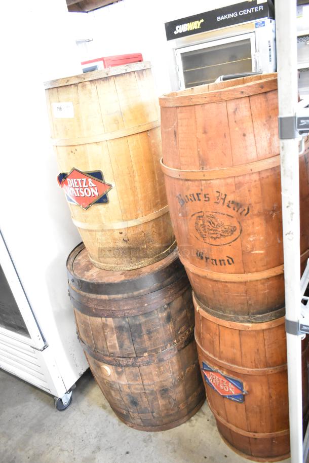 Four wooden barrels, marked "Dietz & Watson" and "Burrs Head Brand," in rustic condition; ideal for decor or storage.