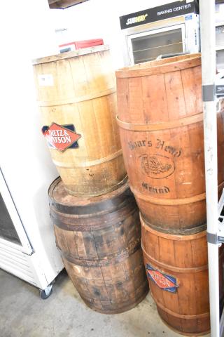 Four wooden barrels, marked "Dietz & Watson" and "Burrs Head Brand," in rustic condition; ideal for decor or storage.