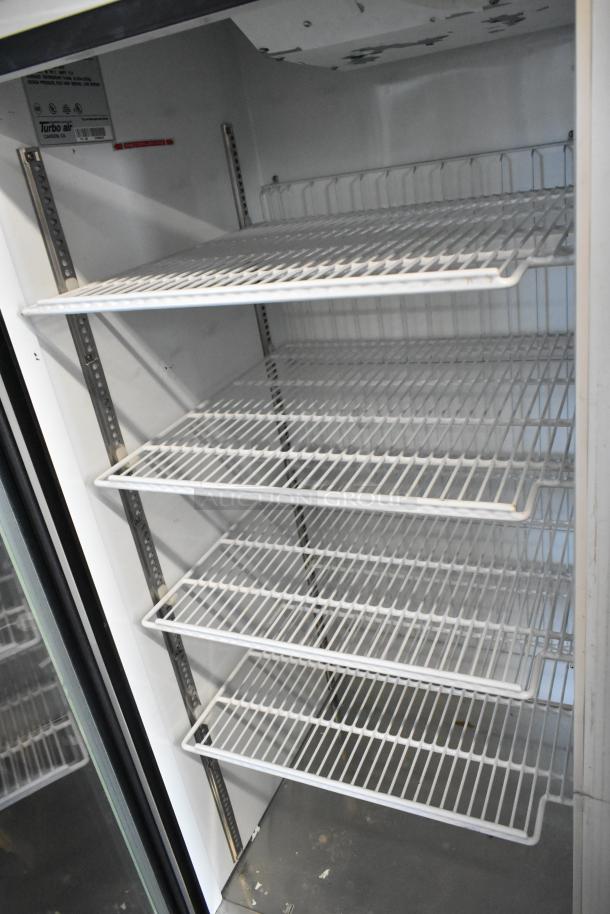 Turbo Air TGF-49F commercial two-door freezer with poly-coated racks and metal interior, on heavy-duty casters.