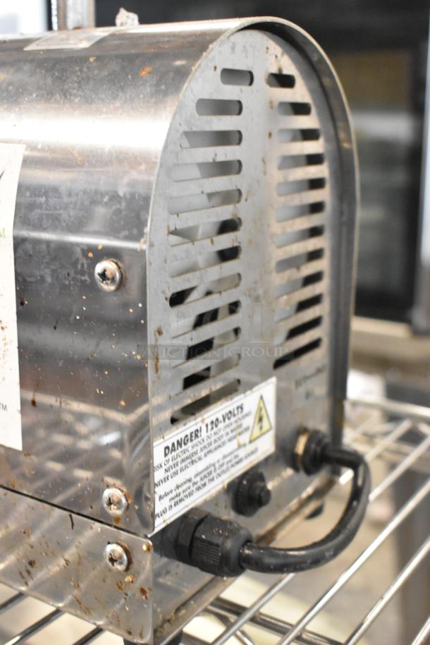 Dr Squeeze stainless steel wheatgrass juicer, 115 volts, 1 phase, in used condition with visible wear, warning label present.