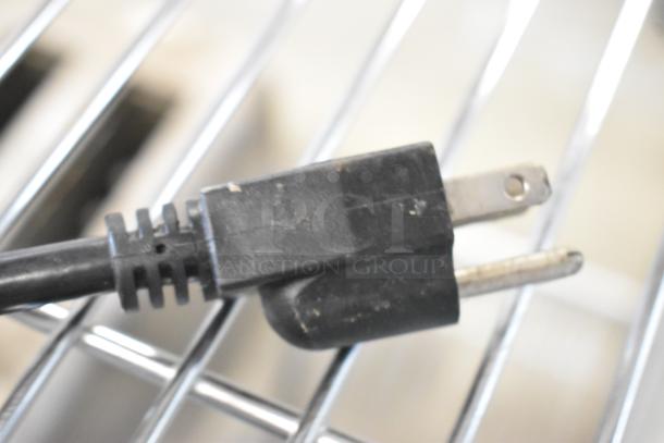 Close-up of a black power plug for the Dr Squeeze Stainless Steel Wheatgrass Juicer, 115 volts, 1 phase.