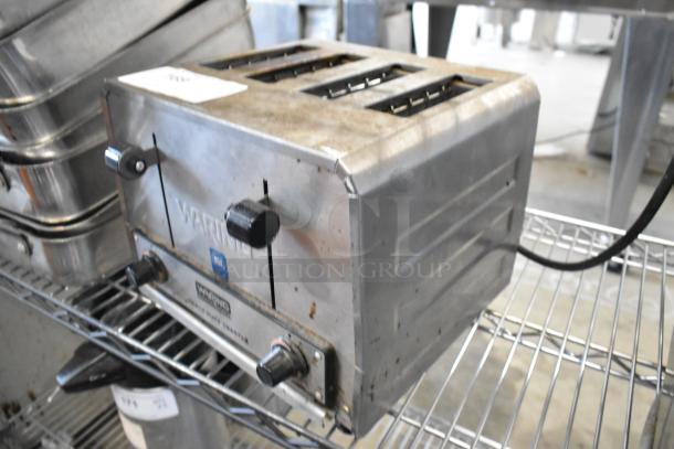 Waring WCT825 stainless steel 4-slot heavy-duty toaster, 240 volts, used condition, visible brand marking and controls.