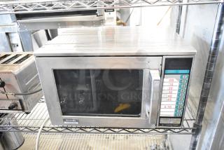 Sharp R-23GT-F stainless steel commercial microwave oven, 208/230 volts, 1 phase. Visible control panel and branding.