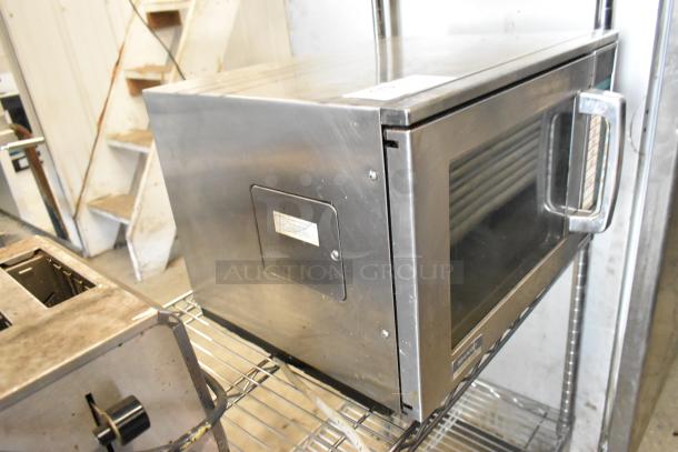 Sharp R-23GT-F stainless steel commercial countertop microwave oven, 208/230 volts, 1 phase, in used condition.