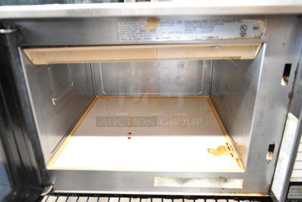 Sharp R-23GT-F stainless steel commercial microwave oven, interior view showing some wear and stains, 208/230V, 1 phase.