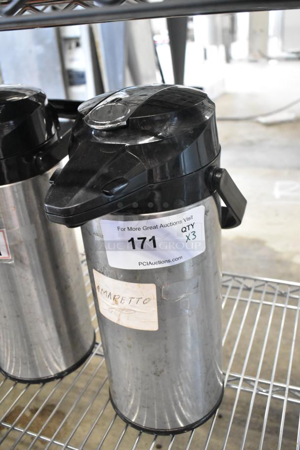 Three metal air pots with black plastic lids on a wire rack. Visible label reads "Amaretto," and auction tag shows "171" and "QTY x3."