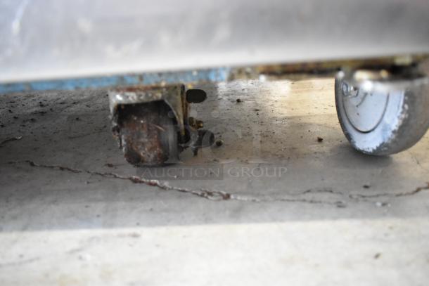 Hoshizaki FH2-AAC freezer caster wheels; one rusted, one intact, attached to stainless steel base. Commercial grade condition.