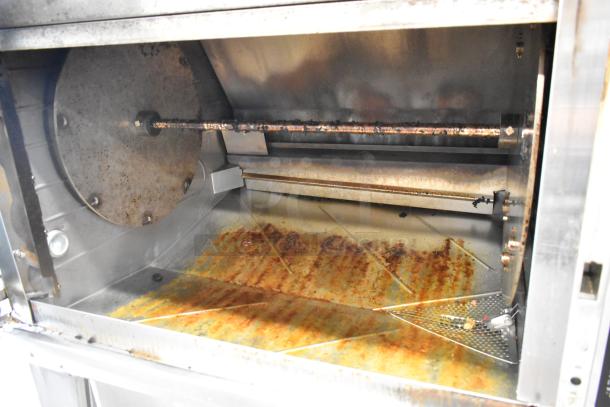 Hardt GC/4000 Stainless Steel Rotisserie Oven, natural gas, on metal legs with casters, interior visible, used condition.