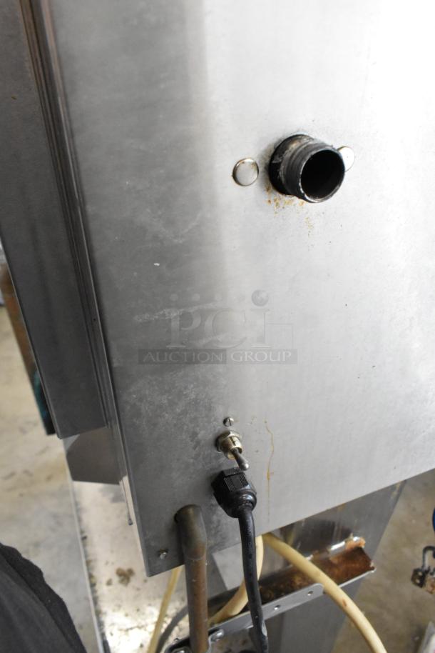 Hardt GC/4000 stainless steel rotisserie oven; natural gas, commercial casters. Metal legs, visible power and switch connections.