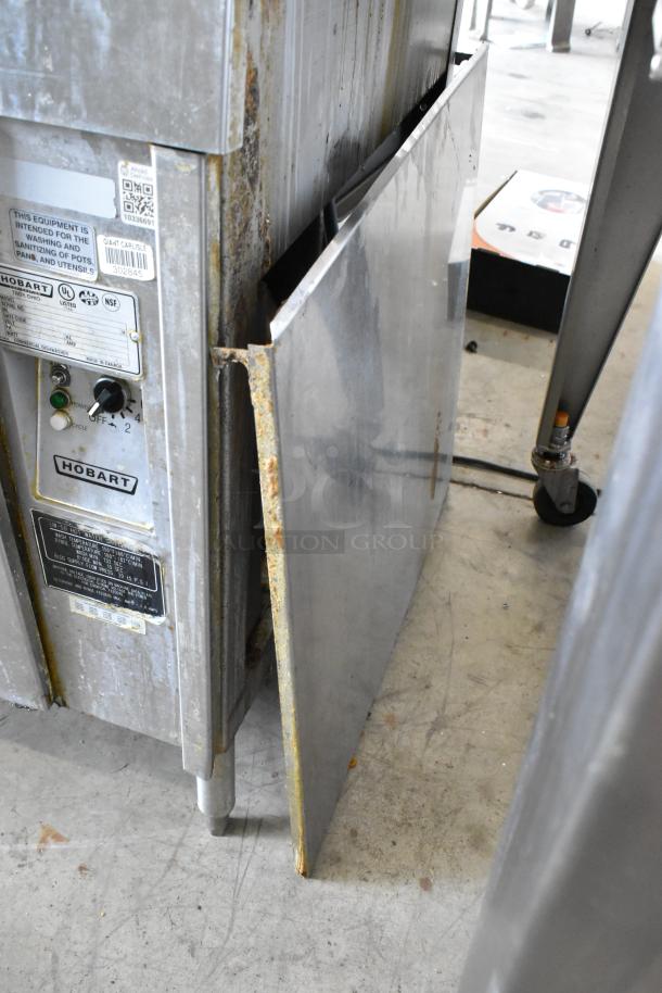 Hobart UW50 stainless steel commercial utensil washer with split door. Signs of wear, rust on edges. 208V, 3 phase.