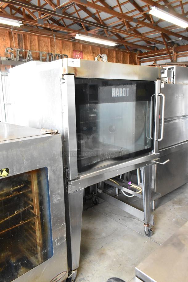 Hardt GC/4000 stainless steel rotisserie oven, natural gas powered, on metal legs with commercial casters.