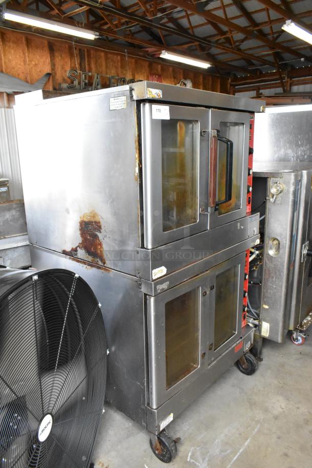 2 Vulcan SG4D-1 stainless steel commercial convection ovens, view-through doors, metal racks, thermostatic controls, casters, bottom doors stuck.