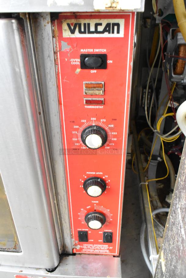 Vulcan SG4D-1 commercial convection oven with stainless steel, view-through doors, thermostatic controls, on casters. Bottom doors stuck.