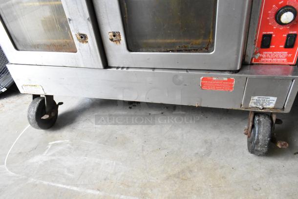 Vulcan SG4D-1 stainless steel commercial convection oven, view-through doors, bottom doors stuck, thermostatic controls, on casters.