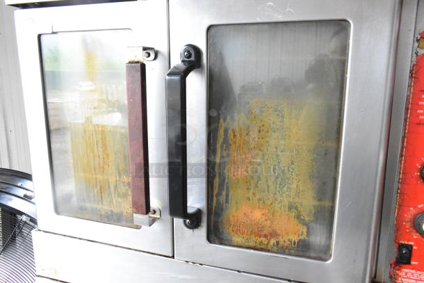 Vulcan SG4D-1 stainless steel convection oven, view doors, metal racks, thermostatic controls, casters; bottom doors stuck.