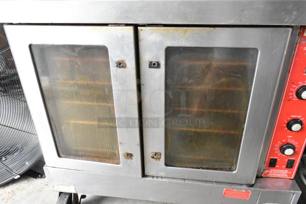 Vulcan SG4D-1 stainless steel convection oven with view-through doors, metal racks, thermostatic controls. Bottom doors stuck.