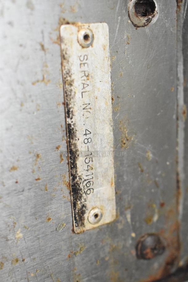 Serial number plate on a Vulcan SG4D-1 stainless steel convection oven, showing wear and some rust.