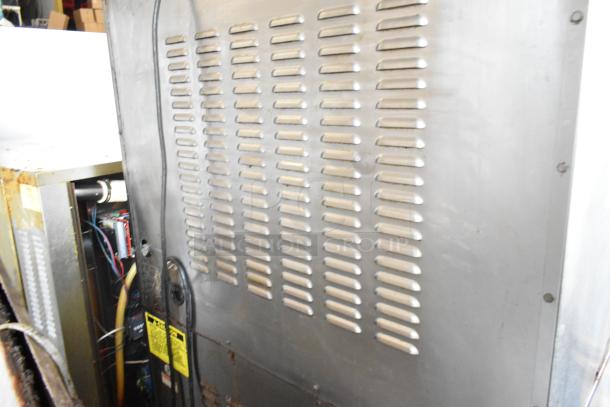 2 Vulcan SG4D-1 stainless steel commercial convection ovens with view-through doors, metal racks, and thermostatic controls. Bottom doors stuck.