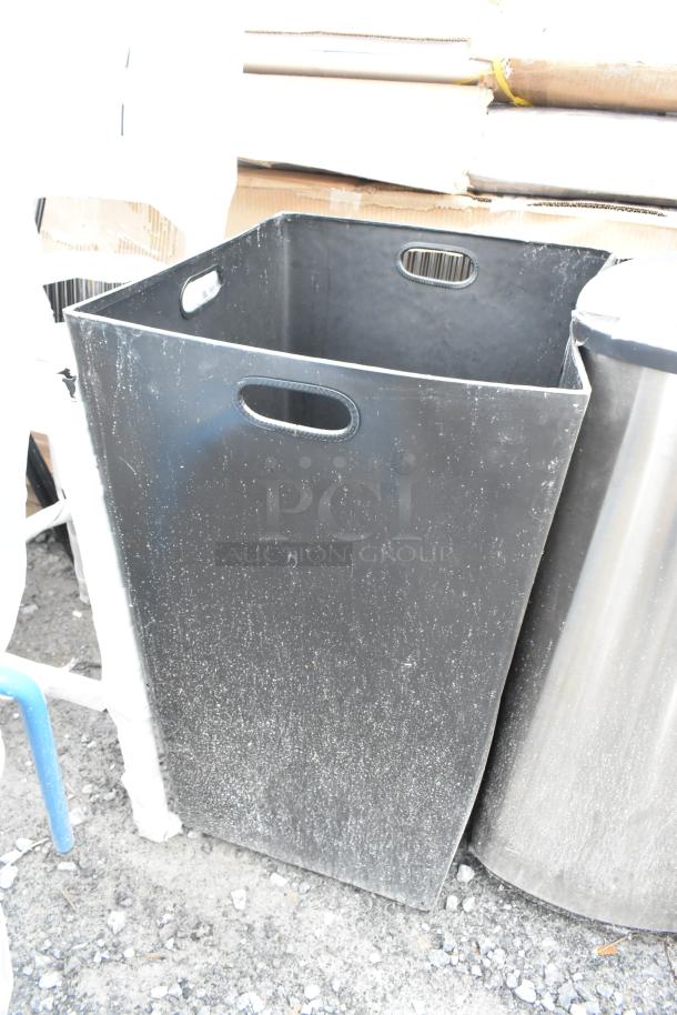 Black trash can shell, new with minor scratches, 16x16x31 inches. Ideal for indoor or outdoor use.