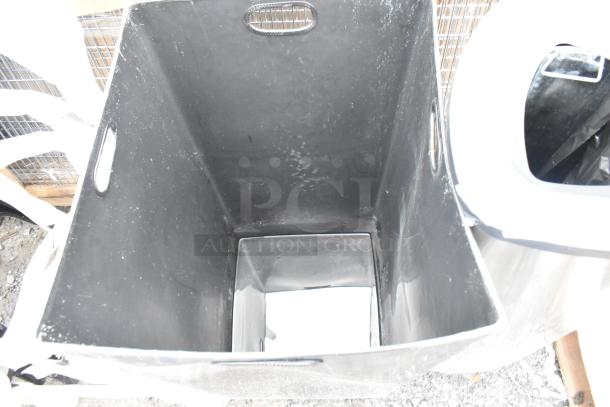 Brand new black trash can and silver trash can shell, 16x16x31 inches, minor scratches and dents, auctioned in pairs.