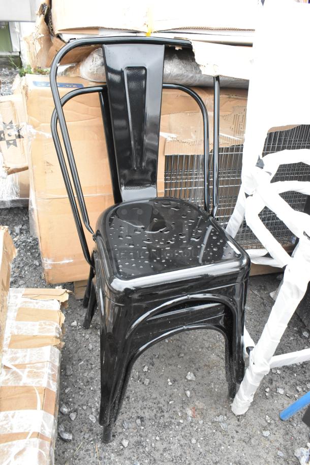 Black metal Tolix-style bar height chair, new condition, scratch and dent, against cardboard boxes.